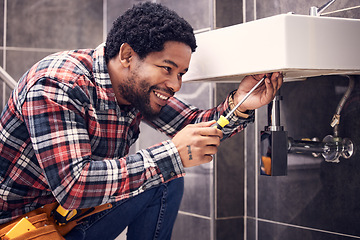 Image showing Happy, man or plumber fixing a sink with smile in maintenance or installation in home repairs. African handyman or worker with plumbing tools to fix water pipes or house basin in renovation project