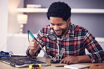 Image showing Black man, technician and fixing computer circuit board in hardware, soldering iron tools or tech repair. Maintenance, magnifying glass or electrical fix with happy male working on device motherboard