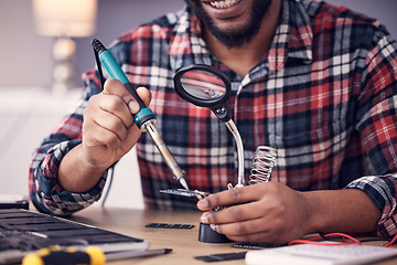 Image showing Man, electrician hands with soldering iron to fix computer hardware, magnifying glass and tech repair. Maintenance, tools and technician fixing electrical problem with male working on device