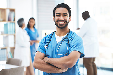 Image showing Medical, arms crossed doctor with portrait of man for healthcare, surgery and happy. Smile, medicine and confident with male nurse standing in hospital for wellness, cardiology and expert