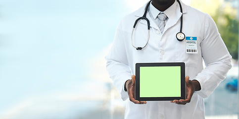 Image showing Hands, tablet and green screen with doctor in hospital for promotion, mockup space and branding. Man, medic and tech touchscreen for telehealth mock up, app and logo in clinic for healthcare promo