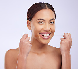 Image showing Portrait, happy and woman flossing teeth on studio background for healthy dental wellness. Female model, oral thread and cleaning mouth of fresh breath, tooth maintenance and care of smile for beauty