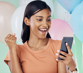 Image showing Winner, phone and happy woman with party balloons for birthday celebration, prize or online giveaway success or news. Yes, fist pump and wow of indian person bonus, lotto or winning deal in studio