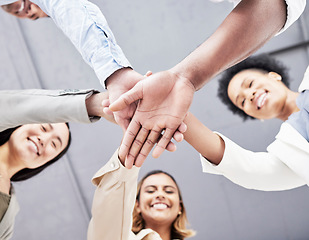 Image showing Business people, hand stack and low angle in circle for teamwork, support and motivation in portrait. Women, team building and hands together for solidarity, diversity and mission for startup company