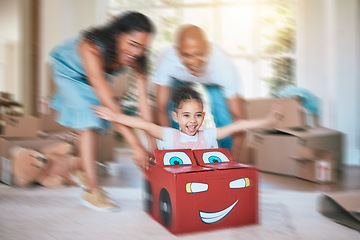 Image showing Family, fun and motion blur with a girl in a toy car, being pushed by her mother and father in the living room. Children, excitement or love with a man, woman and daughter playing together at home