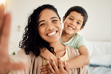 Image showing Smile, selfie and mother with child on a bed hug, love and bonding in their home together. Portrait, embrace or woman with son in bedroom waking up, happy and posing for profile picture, photo or pov