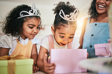 Image showing Girl child, box and wow for gift, surprise or happiness for princess at birthday in family home. Female kid, present and smile with mother, sister and happy at party with tiara, love or bond in house