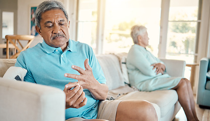 Image showing Divorce, ring and fight with old man at home for separation, breakup and conflict. Marriage problem, relationship issues and finish with couple on sofa with decision for change, disagree and leave