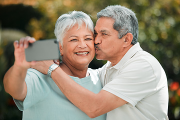 Image showing Senior couple, selfie and kiss in park, garden and smile of profile picture on social media. Happy retirement, man and woman taking photograph of memory, life partner and care in love, support or hug