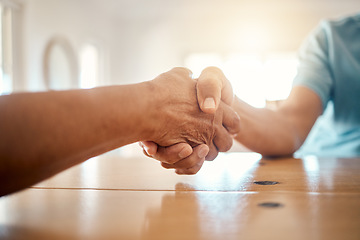 Image showing Handshake, table and hands of people for agreement, thank you and deal for support, unity and partnership. Community, collaboration and closeup of men shaking hand for friendship, trust and care