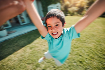 Image showing Kid, swing and pov with a boy spinning outdoor in the garden of his home with a parent closeup. Children, portrait and smile with a youth having fun while swinging outside in the yard during summer