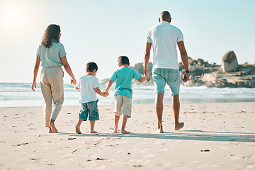 Image showing Beach, holding hands and rear view of family walking at the sea, fun and travel on blue sky background. Behind, love and children with parents on an ocean walk, bond and traveling together in Miami