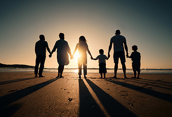 Image showing Family silhouette at beach, generations holding hands at sunset and people with love, care and support outdoor. Travel, adventure and freedom, grandparents and parents with kids back and ocean view