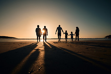 Image showing Silhouette, beach and big family holding hands in sunset on a holiday or vacation at sea or ocean together. Travel, love or shadow of people at sunrise in support, freedom and bonding by water mockup