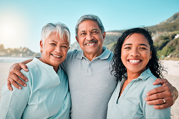 Image showing Senior parents, daughter and smile on beach, hug and happiness in summer vacation together outdoors. Portrait of happy women, man and excited face hugging and smiling on family holiday at the ocean