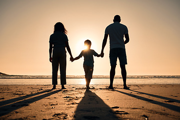 Image showing Family silhouette at the beach, holding hands at sunset and people with love, care and support outdoor. Mom, dad and kid travel, back and ocean view with parents and children outdoor in nature