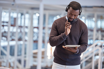 Image showing Call center, tablet and confused black man in office for working, customer support or service. Telemarketing, thinking and technology of serious African person looking for solution or problem solving