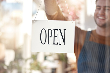 Image showing Happy owner, open sign and small business ready for service, customer help or advertising at store. Man waiter smiling at entrance setting up shop or opening label, poster or billboard at cafe