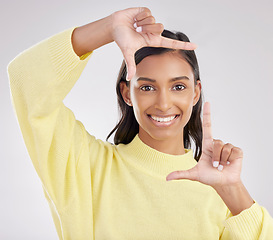 Image showing Finger frame, portrait and happy woman in white background, studio or review profile picture. Face, indian female and hands of model, border perspective and selfie of creativity, smile or photography