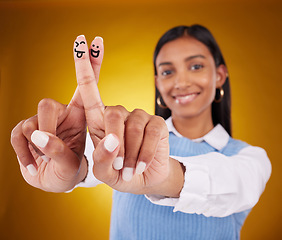 Image showing Fingers, smiley and portrait of indian woman in studio for art, expression and fun on gradient yellow background. Hands, art and drawing by girl smile, excited and content with emoji, gesture or luck