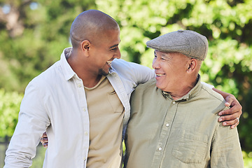 Image showing Love, father and adult son outdoor, hug and happiness with bonding, quality time and cheerful. Family, son and dad with a smile, embrace or loving together in nature, park or happy with care or relax