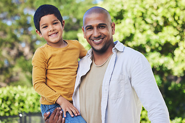 Image showing Portrait, son and father with a smile, outdoor and bonding with happiness, family and cheerful. Face, parent and dad with boy, love or embrace in nature, outside and affection with joy, park or relax