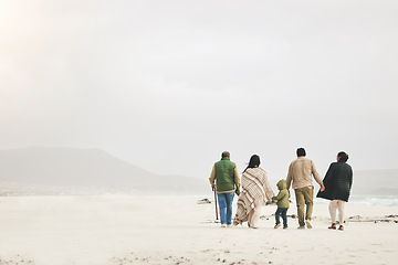 Image showing Children, holding hands and family walking at the beach in winter for quality time, love and care outdoor. Men, women or grandparents with parents and kids with mockup on a travel vacation in winter