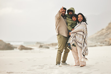 Image showing Mother, father and children at the beach for family time in winter with love and care outdoor in nature. Man, woman and kids on a vacation, holiday or travel trip for bonding and pointing at mockup