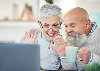 Image showing Laptop, senior couple and wave on video call with coffee in home, talking and speaking in house. Computer, retirement and man and woman waving to say hello in virtual chat, online greeting and happy.