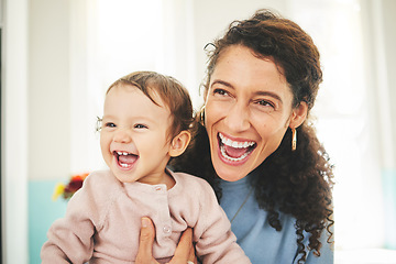 Image showing Mother, laughing baby and a happiness in a family home while together for love, support and care. Woman or mom and girl child laugh for funny or comic joke for quality time, bonding and to relax