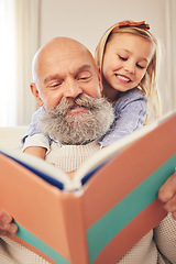 Image showing Grandfather, child and reading a story book in a family home for fun, happiness and learning. A senior man or grandpa and girl kid together for a fairytale, quality time and bonding while happy