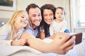 Image showing Family, selfie and smile in a home bedroom with children and parents together on bed for quality time. Man and woman of mother and father with children for a happy profile picture or memory for love