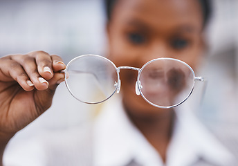 Image showing Vision, glasses in hand and woman in eye care clinic for health, wellness and poor sight exam with blur. Eyesight, girl holding designer brand frame and lens in hands, healthcare and test for eyes.