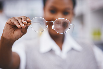 Image showing Eye care, hand and woman holding frame in clinic for health, vision and medical exam for poor sight. Eyesight, girl with designer brand glasses and lens in hand, wellness and help and focus for eyes