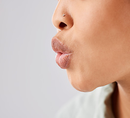 Image showing Pout, lips and woman face whistle with her mouth or kiss with lipstick or gloss isolated in a white studio background. Flirting, care and natural lip of a female person showing love, care and romance