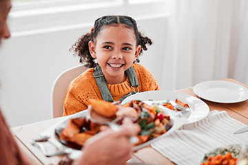 Image showing Family dinner, child and mother with vegetables serving at a home table with happiness on holiday. Food, house and happy eating of a girl with a smile at a gathering with a kid and mom at meal
