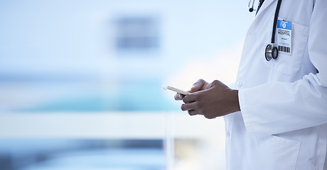 Image showing Doctor, man and hands with phone in healthcare, communication or social media at the hospital. Hand of male medical professional chatting, texting or typing on mobile smartphone for health at clinic