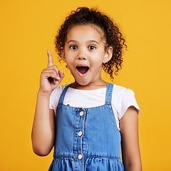 Image showing Idea, surprise and portrait of a girl pointing isolated on a yellow studio background with shock. Plan, knowledge and happy little child with bright ideas, wow and smart planning gesturing to space