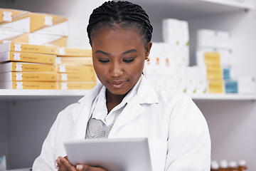 Image showing Black woman in pharmacy with tablet, online inventory list and prescription medicine on shelf. Female pharmacist reading digital checklist, advice and medical professional checking drugs in store.