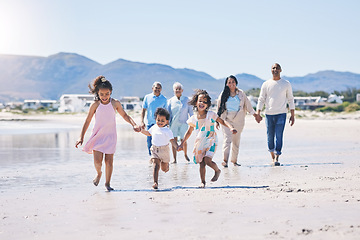 Image showing Beach, big family and children holding hands, running and happiness on summer vacation together in Mexico. Sunshine, fun and bonding, men, women and kids on holiday walk on happy morning with energy.