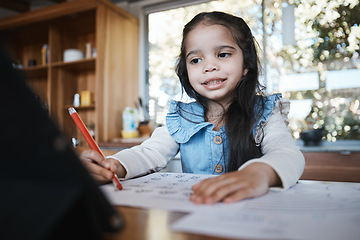 Image showing E learning, education and girl writing at a kitchen table for homework, drawing and home school activity. Online, happy student and kid with paper for sketch, art and lesson for child development