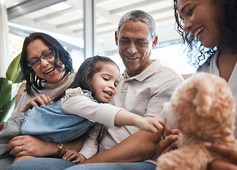 Image showing Love, kids and teddy bear with a family on the sofa in the living room of their home together during a visit. Parents, grandparents and laughing girl in the lounge of a house for bonding or relaxing