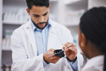 Image showing Vision help, cleaner or glasses lens for man in pharmacist work helping a customer at pharmacy. Shop, eyewear clean and healthcare worker in a wellness and retail store working at a clinic with frame