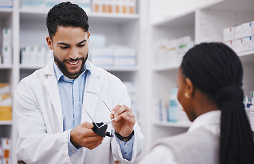 Image showing Vision, lens or cleaning glasses for man in pharmacist work helping a customer at pharmacy shop. Cleaner, eyewear clean and happy healthcare worker in a retail store working at a clinic with a frame