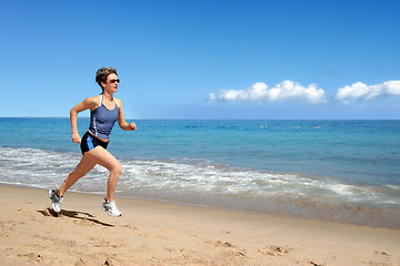 Image showing Girl running on the beach