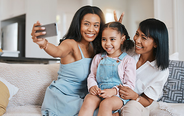 Image showing Peace sign selfie, grandmother and kid with mother in home living room, bonding or having fun. Family, smile and girl with grandma and mama, care or taking pictures on sofa with v hand emoji together