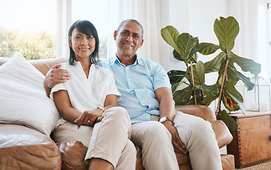 Image showing Portrait, senior couple and smile in home living room on sofa, bonding and embrace in house. Couch, retirement and happiness of man and woman relaxing and enjoying quality time together in lounge.