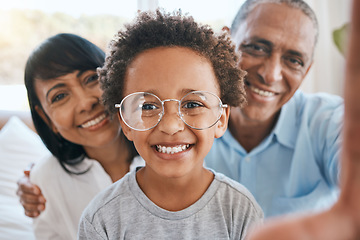 Image showing Glasses, grandparents and selfie smile with kid in home living room, bonding and having fun. Photo, happiness and portrait of child with grandma and grandpa taking face pictures for family memory.