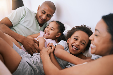 Image showing Happy family, relax and playing in bed with smile for free time, weekend or fun holiday morning at home. Mother, father and children relaxing and laughing together for playful joy in the bedroom