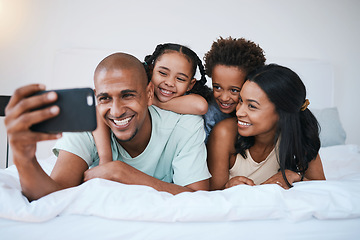 Image showing Selfie, family and smile in home bedroom, bonding and relaxing or lying together. Bed, photo and children with mother and father taking pictures for happy memory, social media or profile picture.